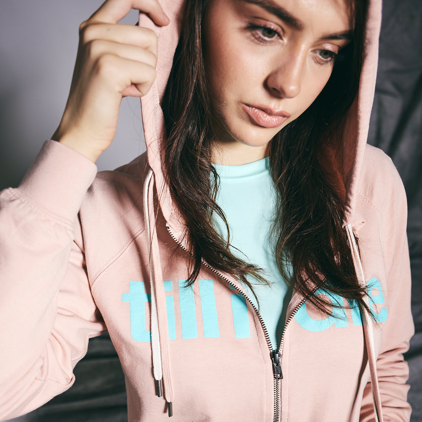 Girl laughing in a blue hoodie with Till I Die printed on it