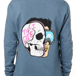 FEMALE MODEL WEARING A BLUE HOODIE WITH THE HOOD UP, FEATURING A GRAPHIC OF A CARTOON HALF SKELETON HALF SKIER HEAD WITH THE WORDS 'TILL I DIE'