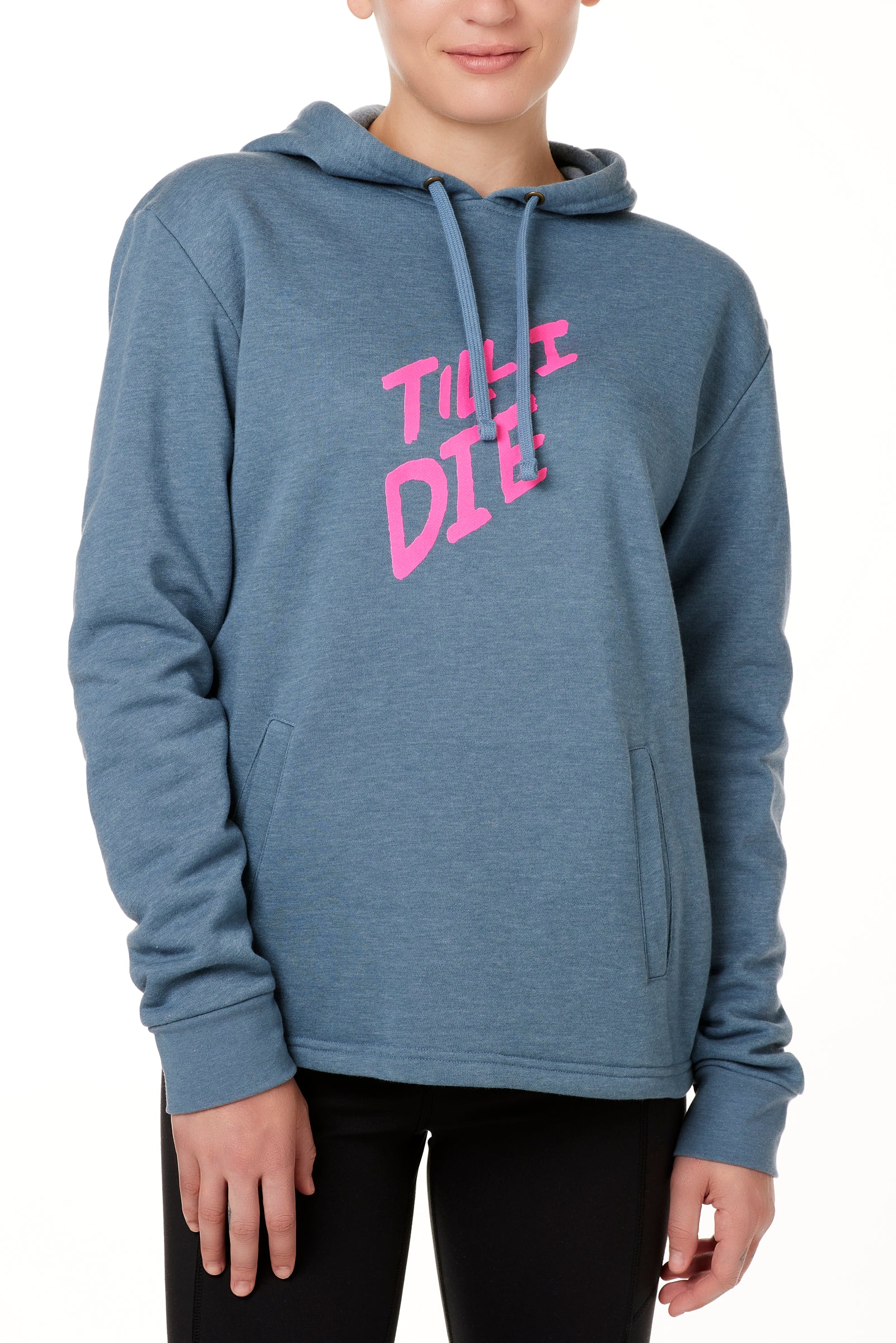A female model wearing a BLUE hoodie with the text 'TILL I DIE' printed in pink on the front.