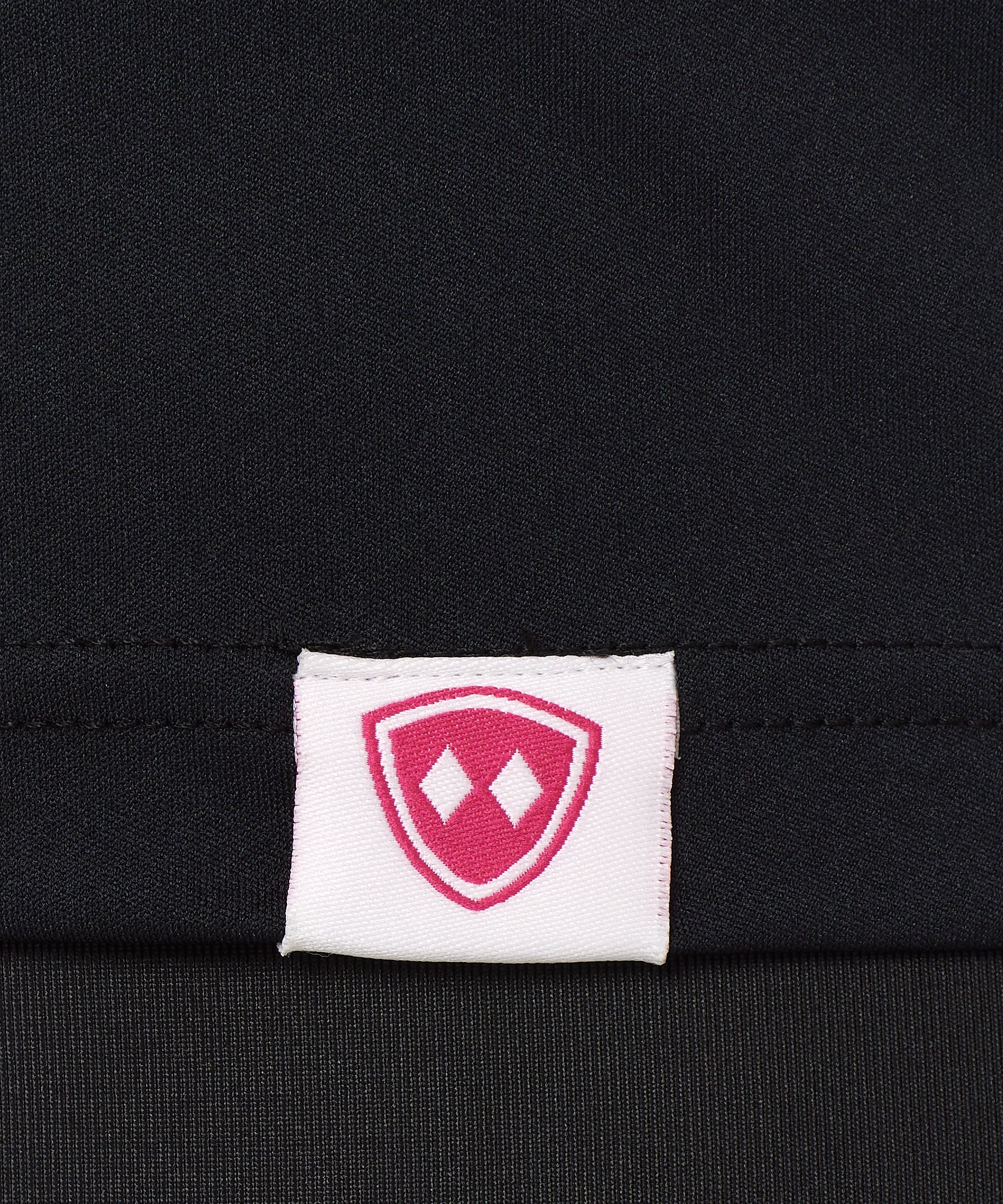 DETAIL OF A BLACK SHIRT WITH A TILL I DIE WOVEN HEM TAG