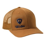 Caramel trucker hat with a navy till i die logo embroidered on the bottom right panel