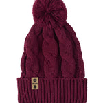 A burgundy cable-knit beanie hat with a matching pom-pom on top and a ribbed cuff featuring a Till I Die Logo leather tab, shown against a plain white background.
