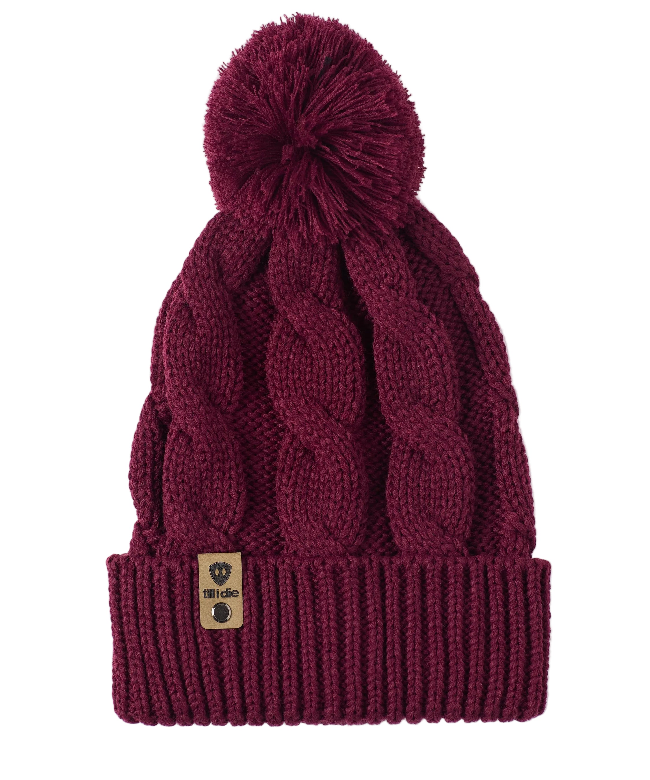 A burgundy cable-knit beanie hat with a matching pom-pom on top and a ribbed cuff featuring a Till I Die Logo leather tab, shown against a plain white background.