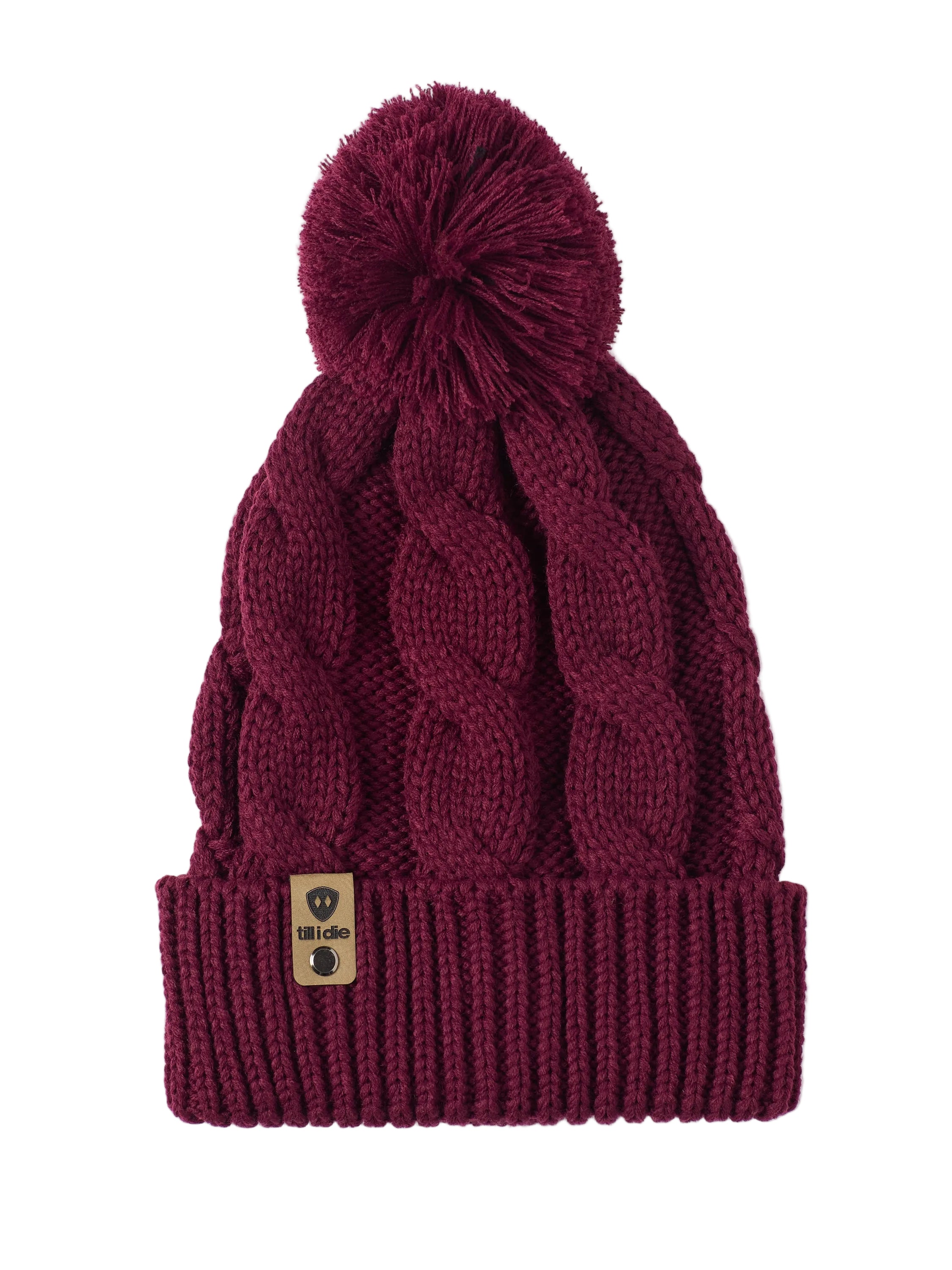 A burgundy cable-knit beanie hat with a matching pom-pom on top and a ribbed cuff featuring a Till I Die Logo leather tab, shown against a plain white background.