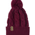 A burgundy cable-knit beanie hat with a matching pom-pom on top and a ribbed cuff featuring a Till I Die Logo leather tab, shown against a plain white background.