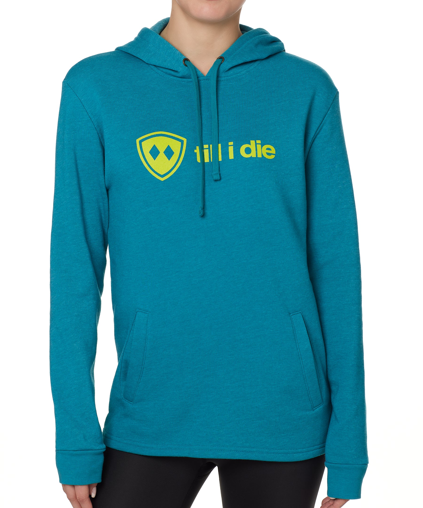 Front view of a female model wearing the Heather Teal Logo Hoodie on a white background. Features a bold bright yellow “Till I Die” logo printed across the chest, separated welt front pockets, and dyed-to-match drawstrings.
