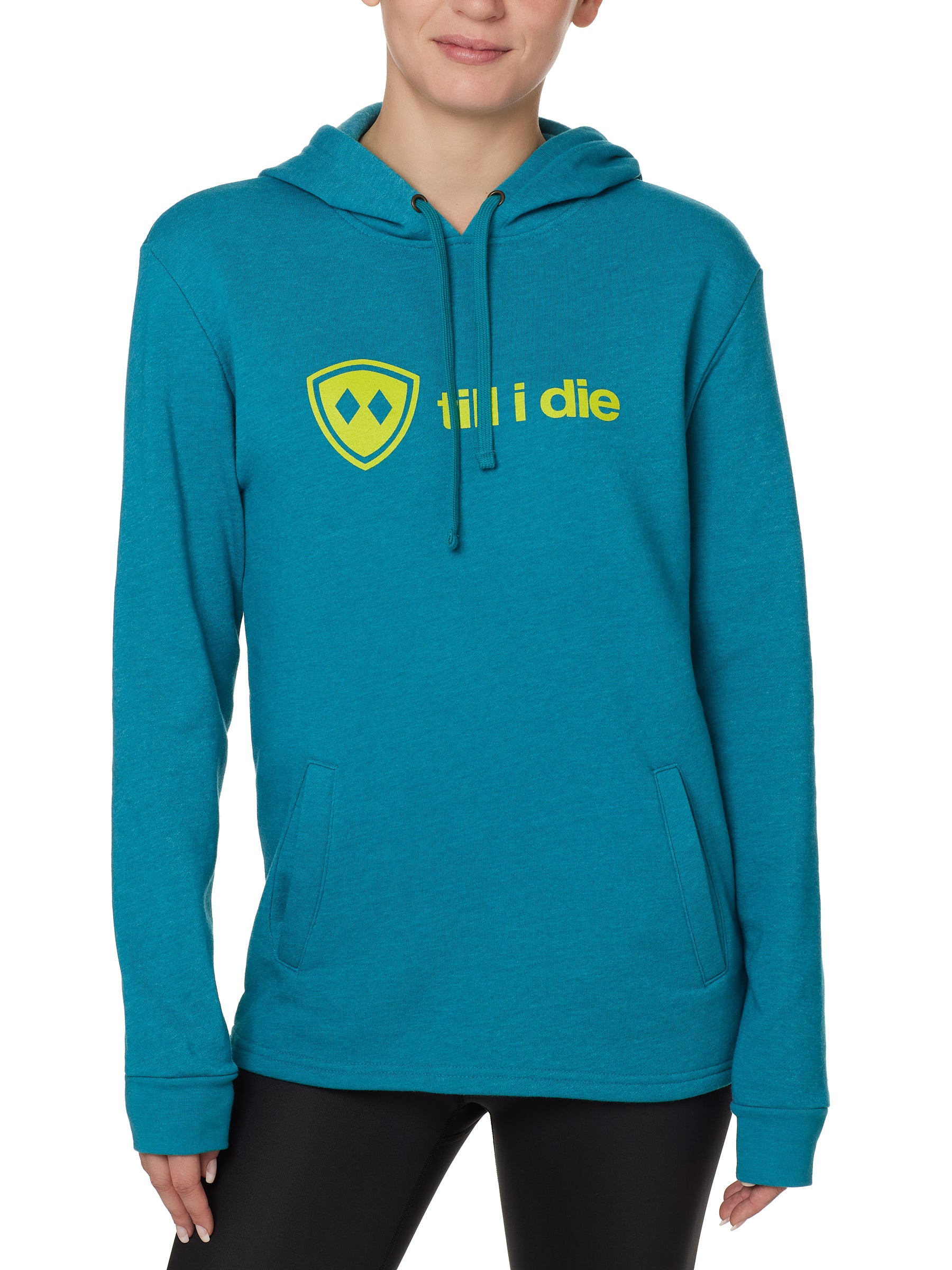 Front view of a female model wearing the Heather Teal Logo Hoodie on a white background. Features a bold bright yellow “Till I Die” logo printed across the chest, separated welt front pockets, and dyed-to-match drawstrings.