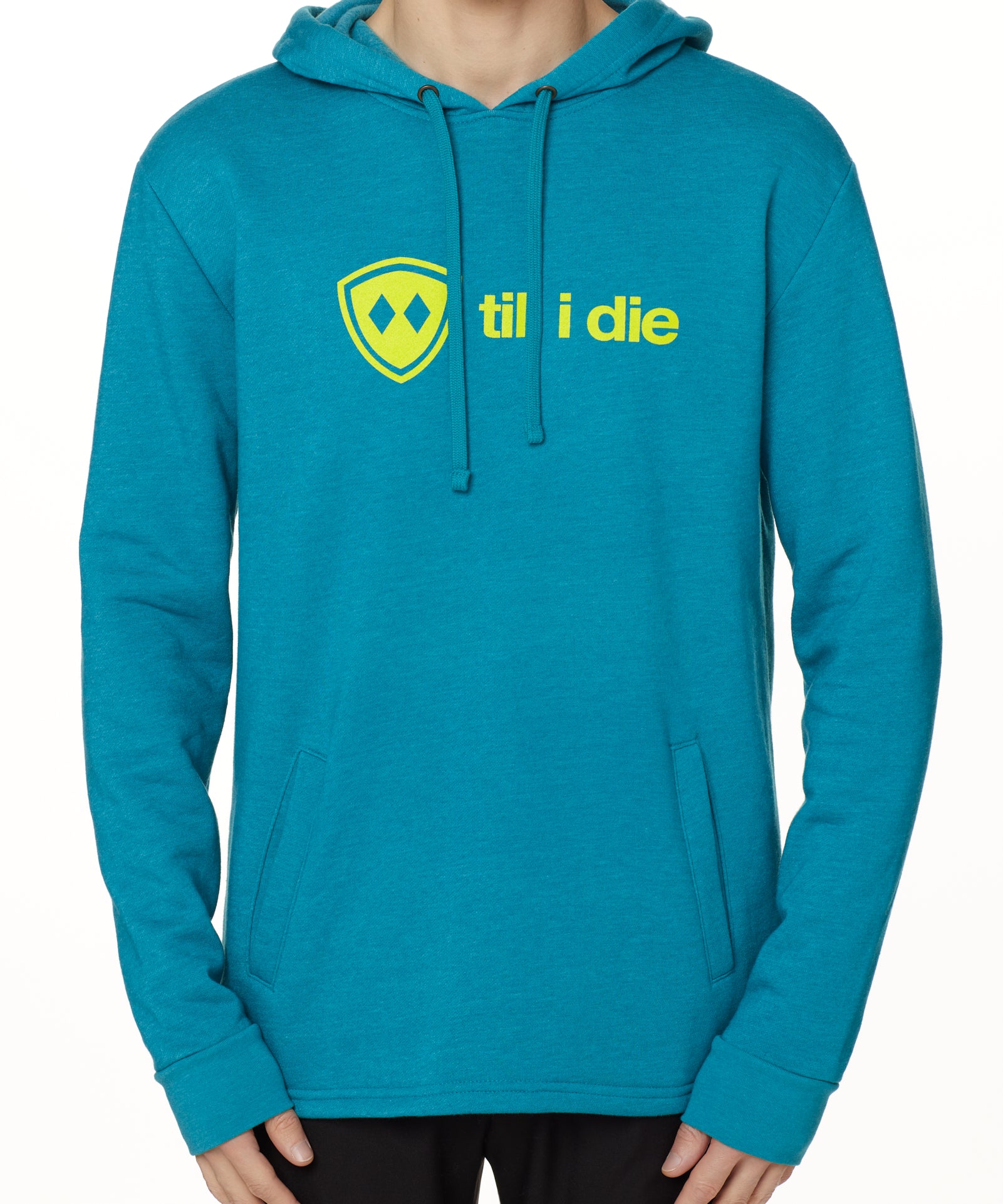 Front view of a male model wearing the Heather Teal Logo Hoodie on a white background. Features a bold bright yellow “Till I Die” logo printed across the chest, separated welt front pockets, and dyed-to-match drawstrings.