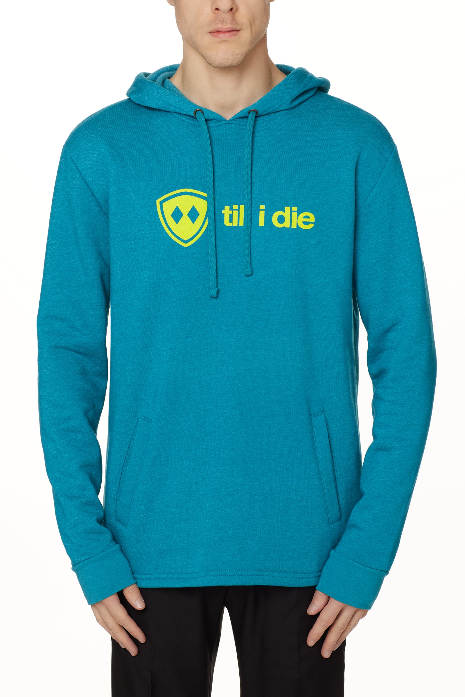 Front view of a male model wearing the Heather Teal Logo Hoodie on a white background. Features a bold bright yellow “Till I Die” logo printed across the chest, separated welt front pockets, and dyed-to-match drawstrings.