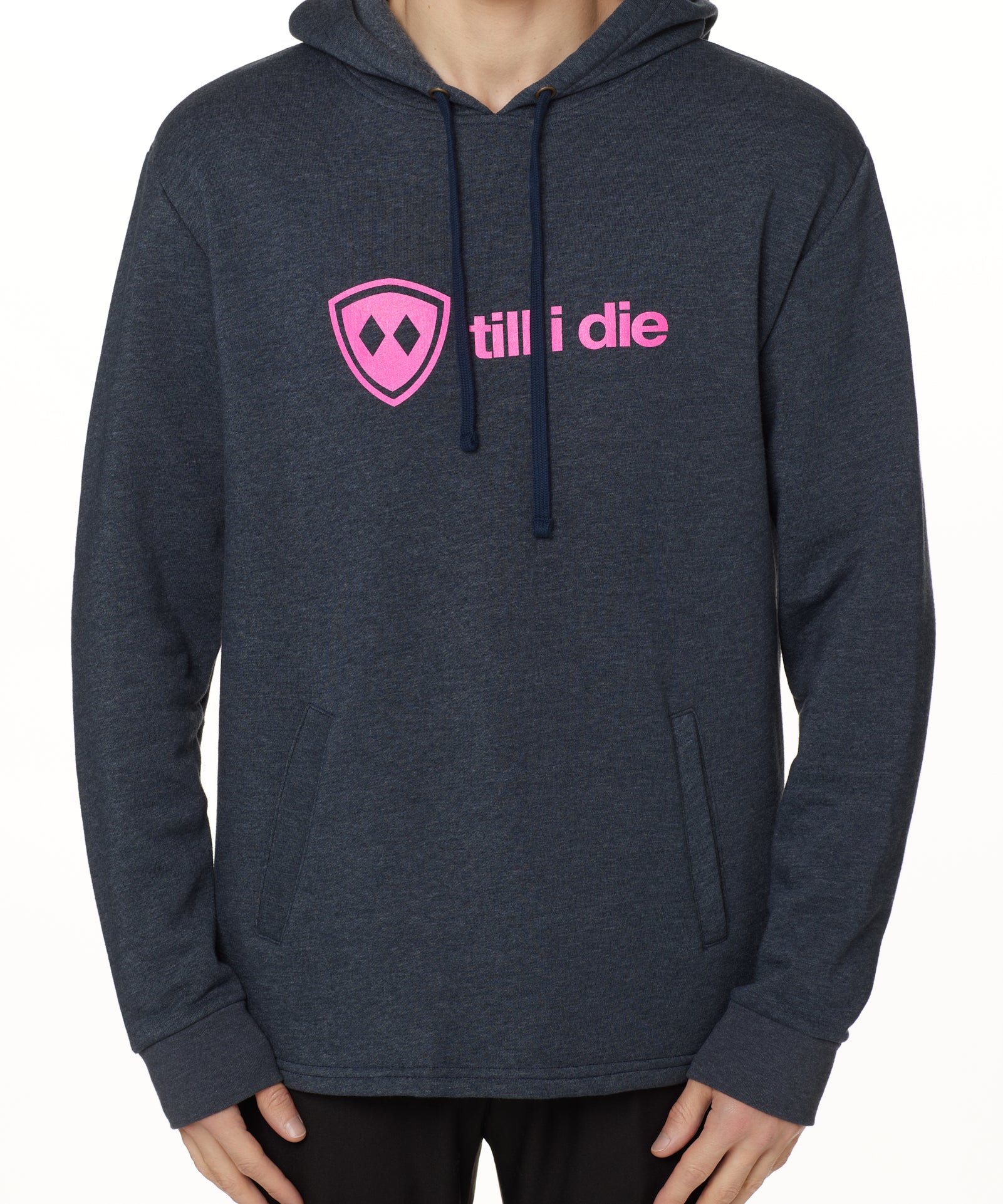 Front view of a male model wearing the Heather Navy Logo Hoodie on a white background. Features a bold bright pink “Till I Die” logo printed across the chest, separated welt front pockets, and dyed-to-match drawstrings.