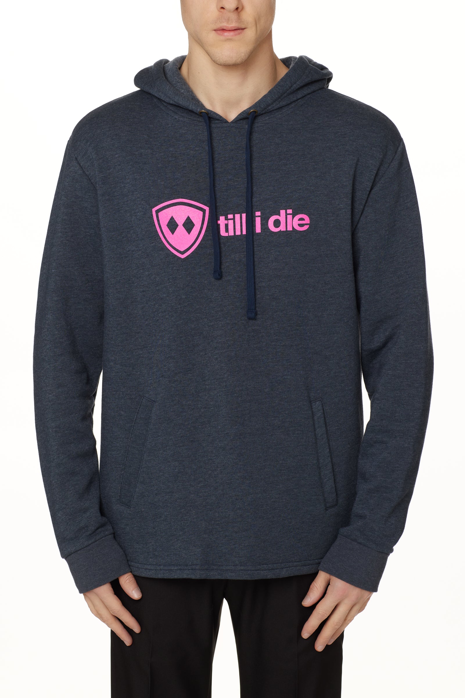 Front view of a male model wearing the Heather Navy Logo Hoodie on a white background. Features a bold bright pink “Till I Die” logo printed across the chest, separated welt front pockets, and dyed-to-match drawstrings.