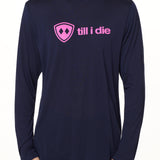 front view of a male model wearing a navy blue long sleeve tee with a hot pink till i die logo across the chest