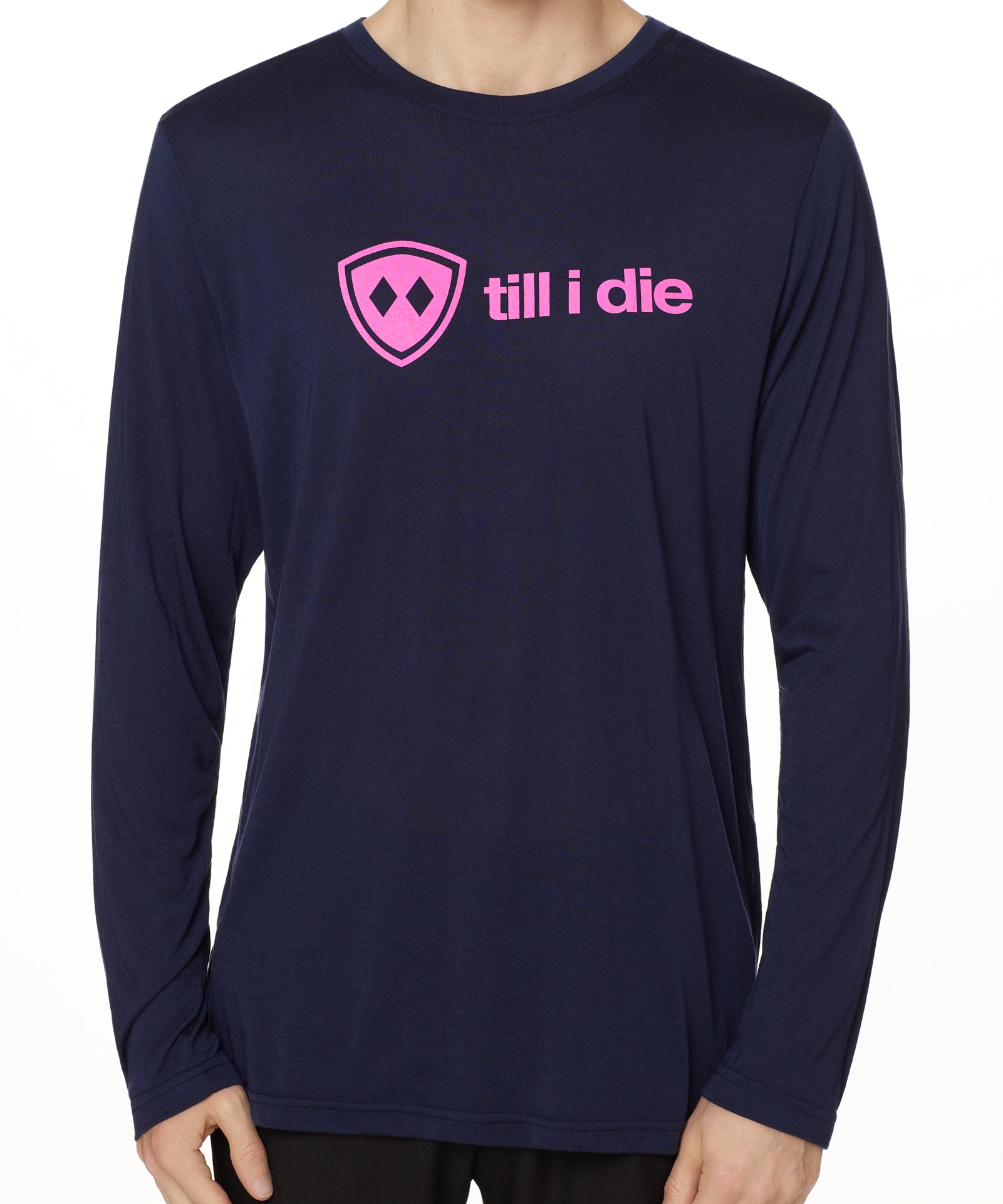 front view of a male model wearing a navy blue long sleeve tee with a hot pink till i die logo across the chest