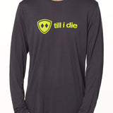 front view of a male model wearing a gray long sleeve tee with a bright yellow till i die logo across the chest
