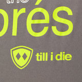 close up detail of the lime green till i die logo on the Aprés shirt