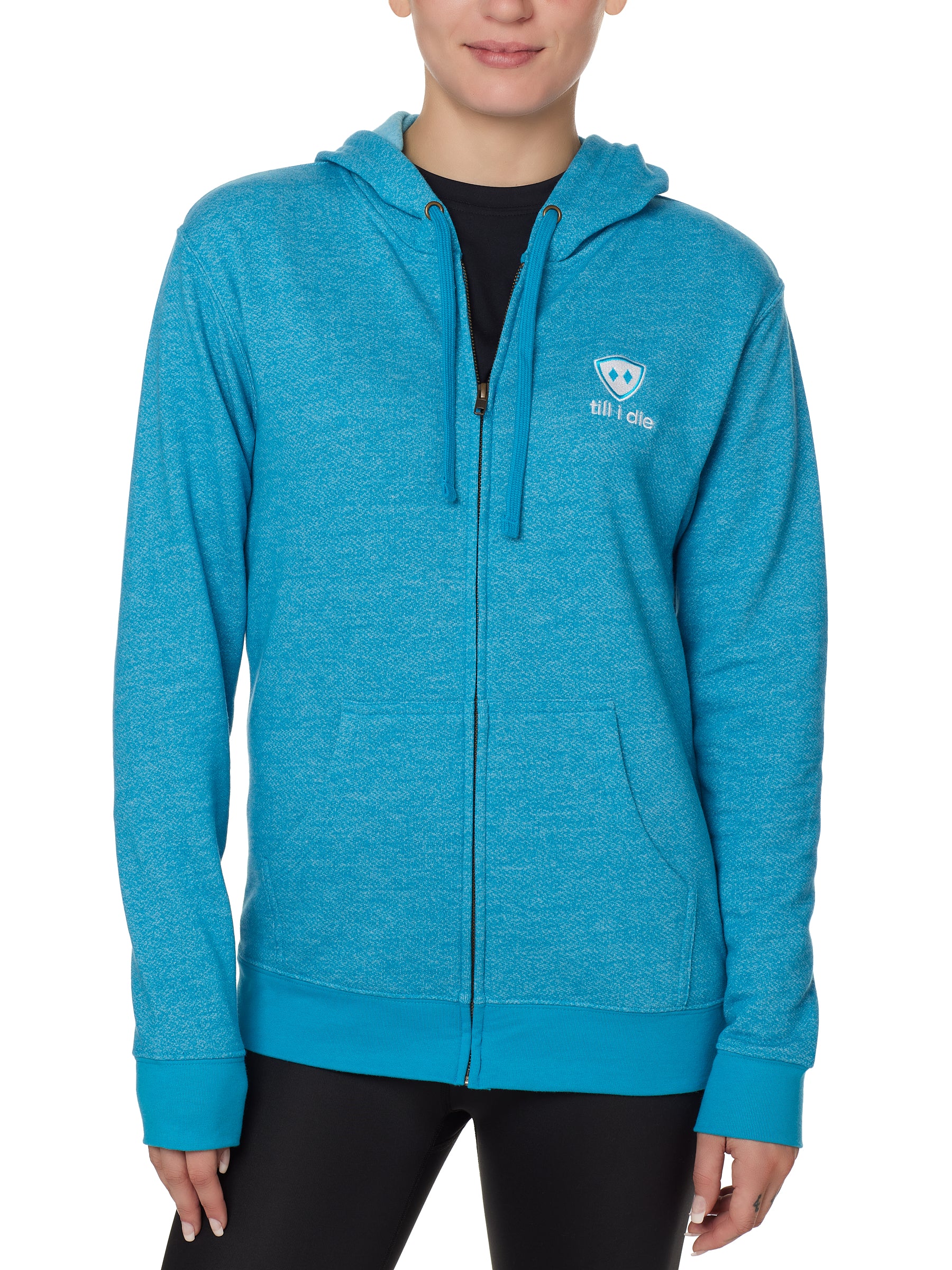 FEMALE MODEL WEARING A HEATHER TEAL ZIP HOODIE WITH THE TILL I DIE LOGO EMBROIDERED IN WHITE AND TEAL ON THE FRONT