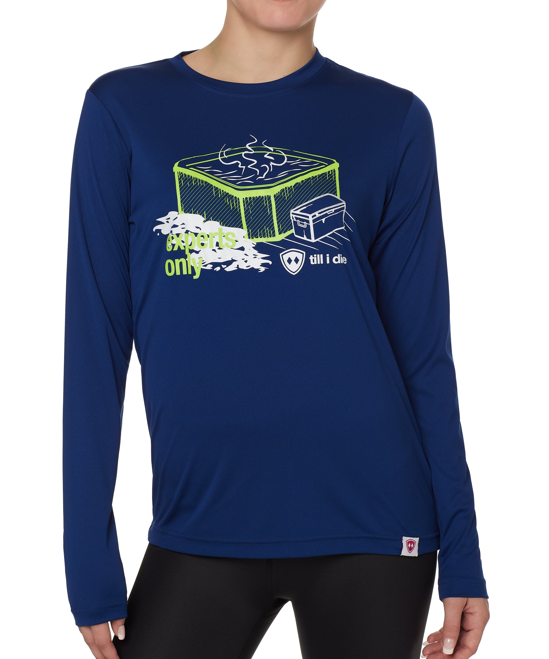 FEMALE MODEL WEARING A BLUE LONG SLEEVE PERFORMANCE SHIRT WITH A GRAPHIC OF A HOT TUB AND THE WORDS "EXPERTS ONLY"