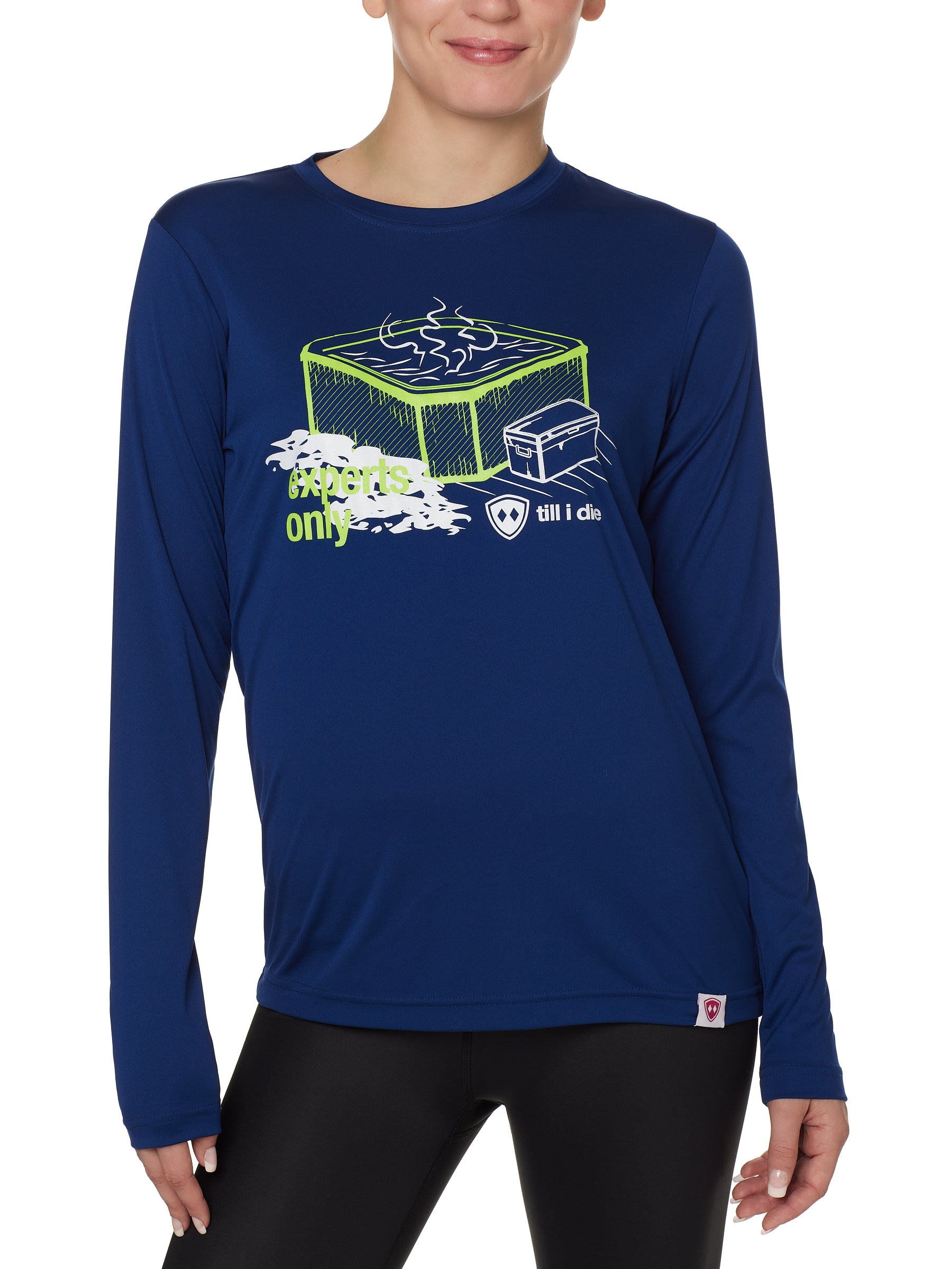 FEMALE MODEL WEARING A BLUE LONG SLEEVE PERFORMANCE SHIRT WITH A GRAPHIC OF A HOT TUB AND THE WORDS "EXPERTS ONLY"