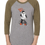 Front view of a male model wearing the Two Dollars Raglan 3/4 sleeve tee. The shirt features military green sleeves and a heather gray body, with a graphic of a ski biker in a full-face helmet. Above the illustration is “Till I Die…” text.