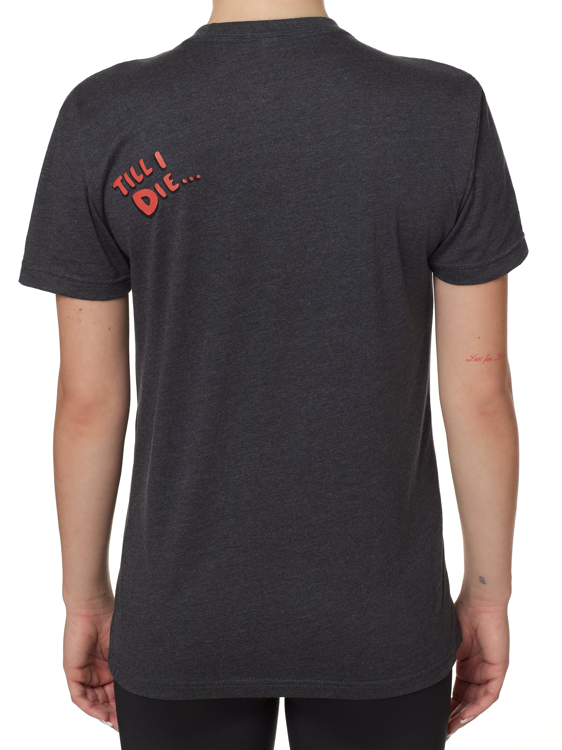 back view of a female wearing a heather slate crew neck tee shirt with a red bubble letter 'till i die'' of wearers top left shoulder 