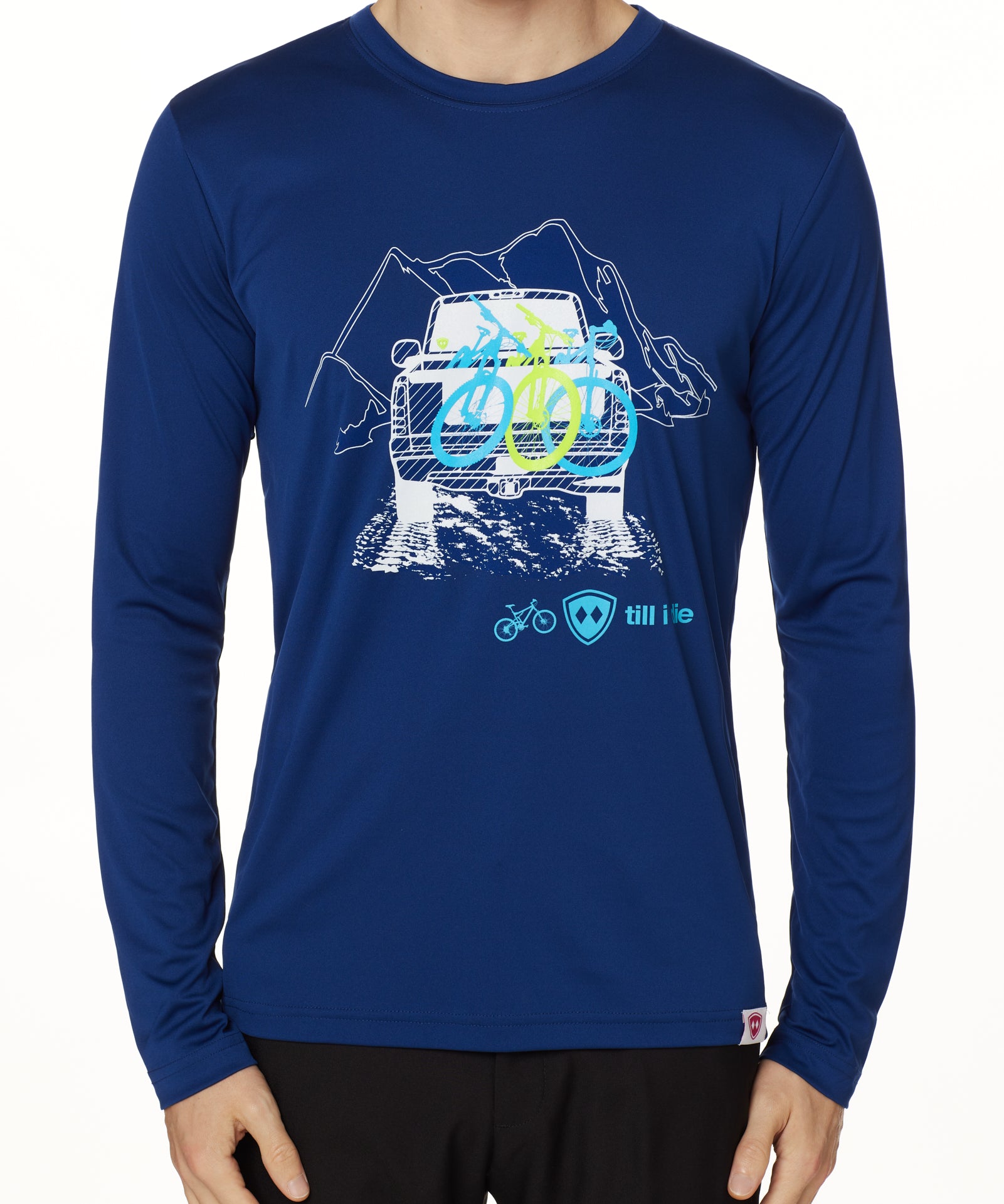 A man wearing a navy blue long sleeve shirt with a graphic print of a truck carrying mountain bikes, and the TILL I DIE LOGO