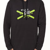 Front view of a male model wearing the Iron Cross hoodie in heather black, displayed on a white background. The graphic features lime green crossed skis with poles, overlaid with bold black and white “Till I Die” text for a striking, alpine-inspired statement.