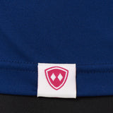 DETAIL OF A BLUE PERFORMANCE SHIRT WITH THE TILL I DIE SHIELD LOGO ON A WOVEN HEM TAG