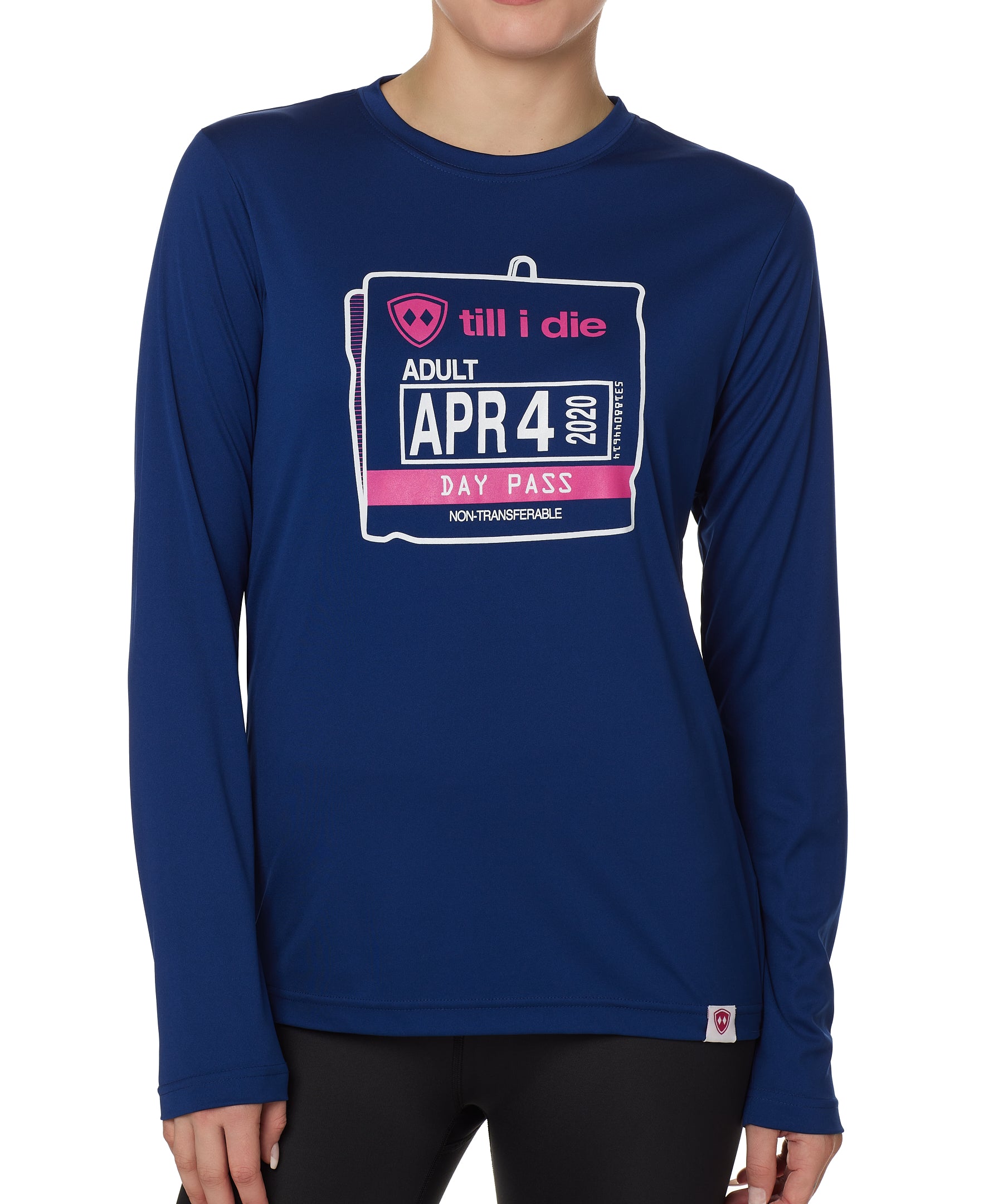 FEMALE MODEL WEARING A BLUE PERFORMANCE LONG SLEEVE SHIRT WITH A GRAPHIC OF AN OLD SKI DAY PASS
