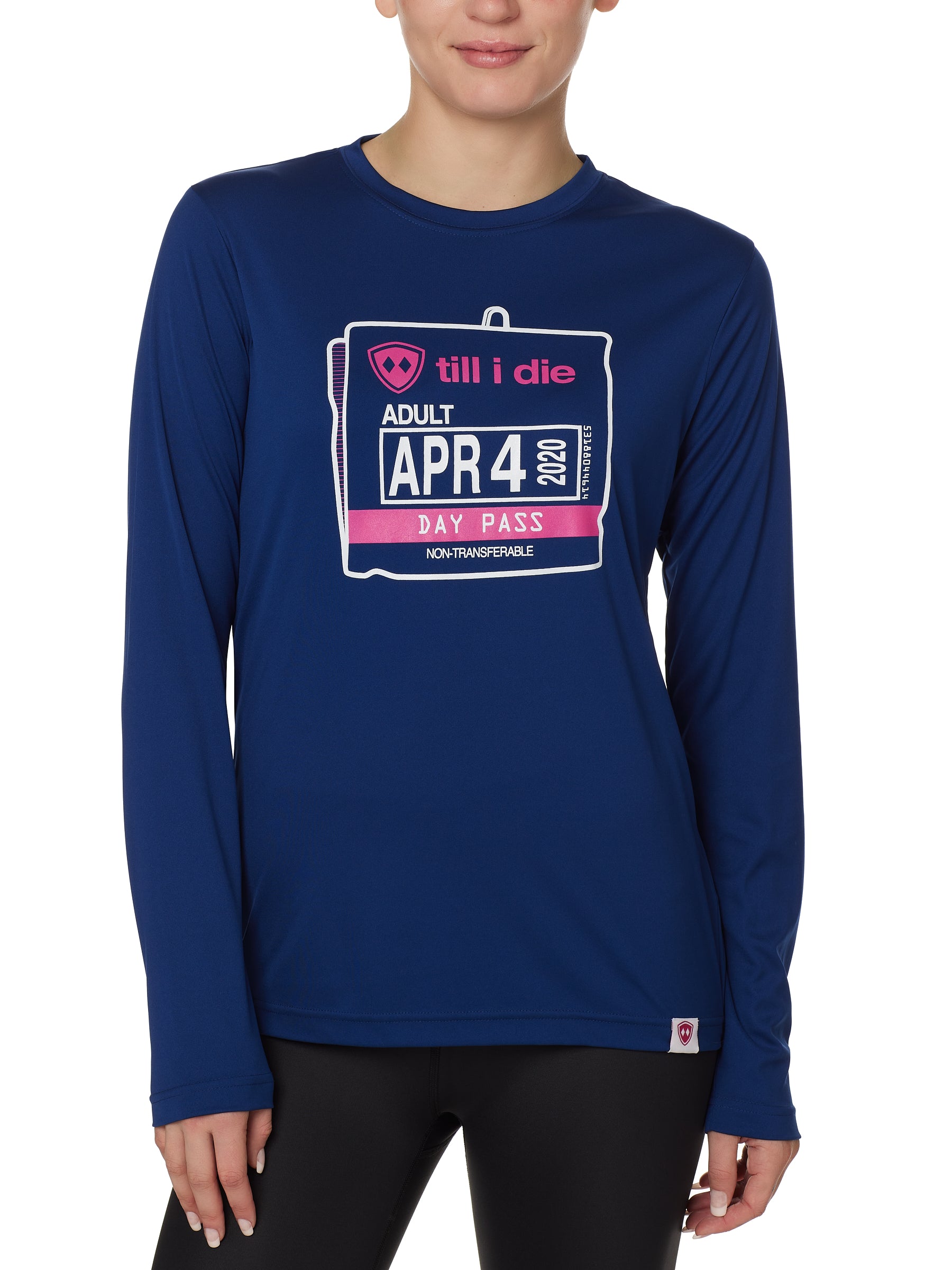 FEMALE MODEL WEARING A BLUE PERFORMANCE LONG SLEEVE SHIRT WITH A GRAPHIC OF AN OLD SKI DAY PASS
