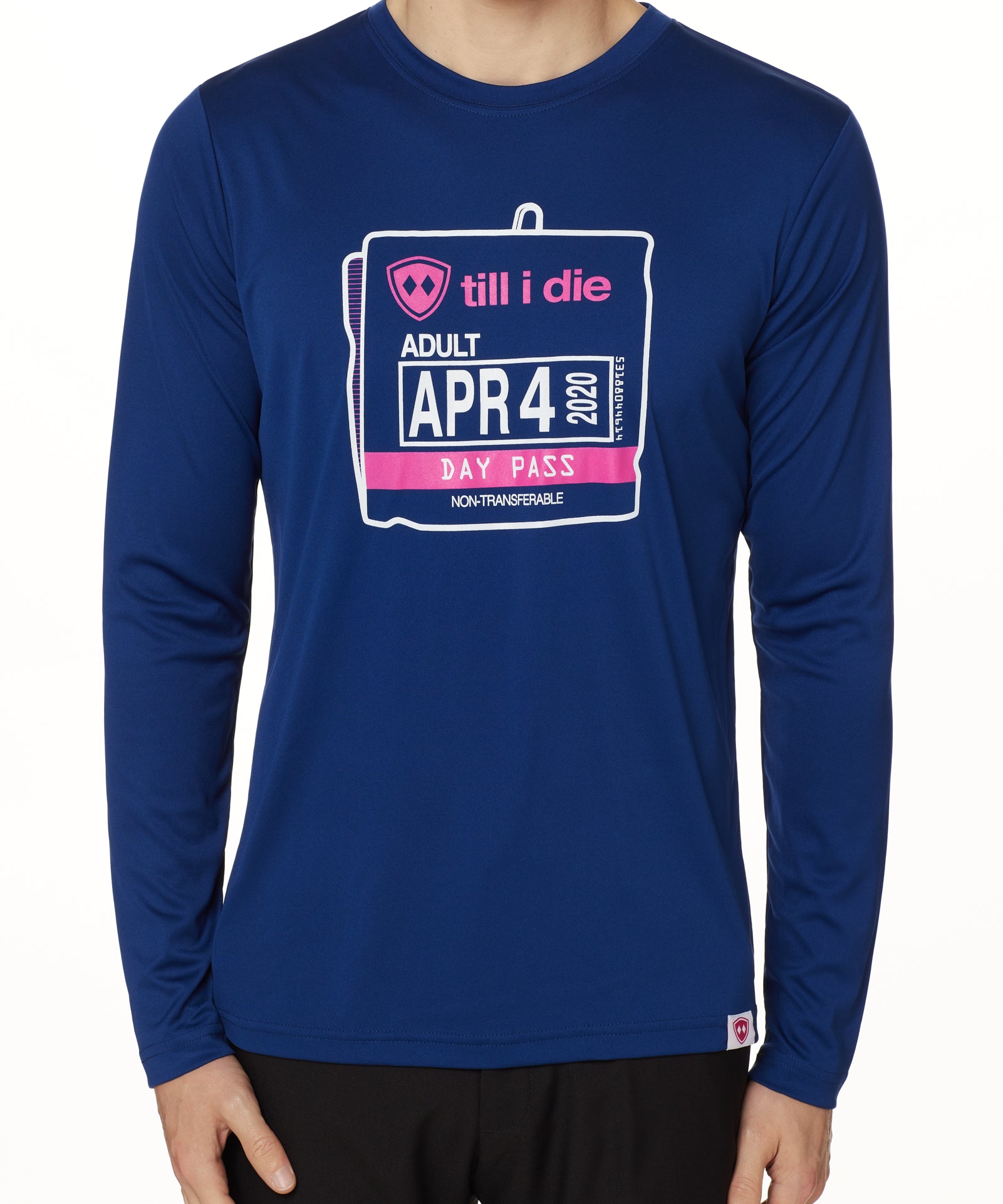 MALE MODEL WEARING A BLUE PERFORMANCE LONG SLEEVE SHIRT WITH A GRAPHIC OF AN OLD SKI DAY PASS