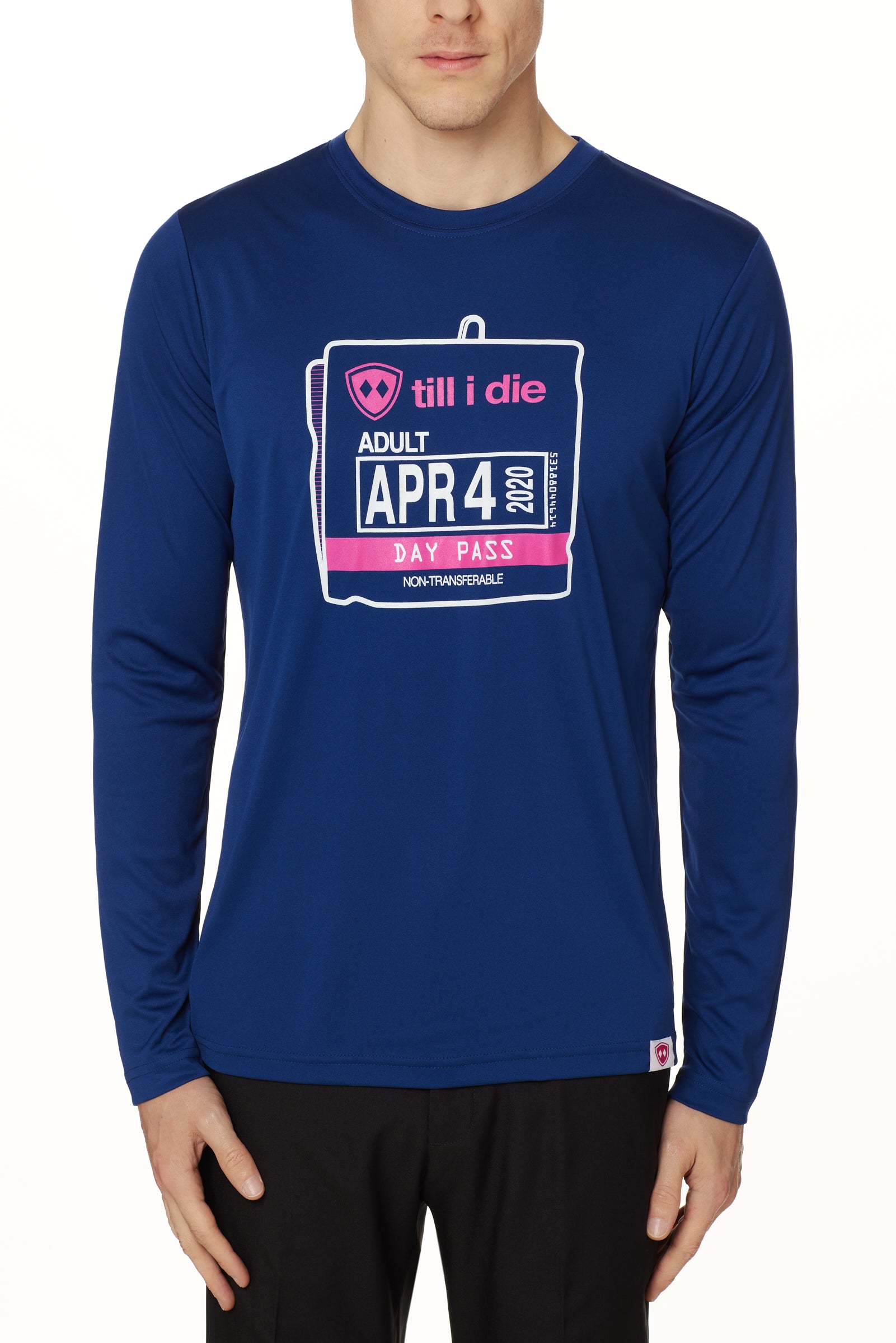 MALE MODEL WEARING A BLUE PERFORMANCE LONG SLEEVE SHIRT WITH A GRAPHIC OF AN OLD SKI DAY PASS