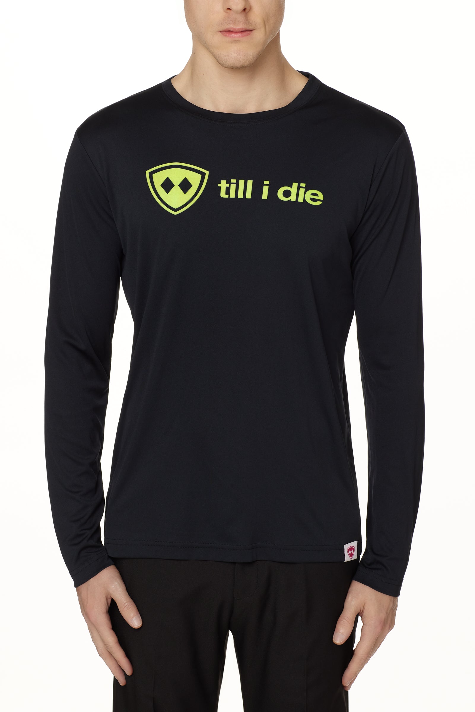 front view of a male model wearing a black long sleeve tee with a bright yellow till i die logo on a white background