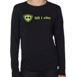 front view of a female model wearing a black long sleeve tee with a bright yellow till i die logo on a white background