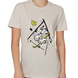 Front view of a female model wearing the Yard Sale crew neck tee in sand, shown on a white background. The graphic features a cartoon skier mid-crash, upside down and losing a hat, gloves, and poles, with a speech bubble that reads “Yard Sale.”