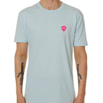 Front view of a male model wearing the Till I Die Bike V-Neck Tee in Light Blue on a white background. The shirt features a pink Double Diamond Shield logo on the wearer's left chest.