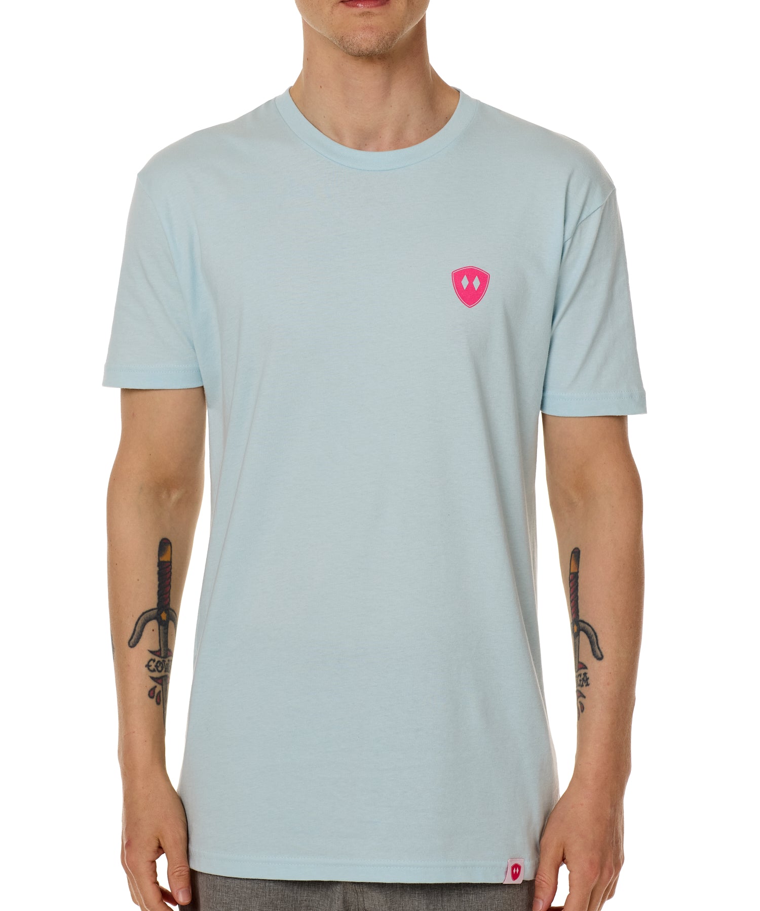 Front view of a male model wearing the Till I Die Bike V-Neck Tee in Light Blue on a white background. The shirt features a pink Double Diamond Shield logo on the wearer's left chest.