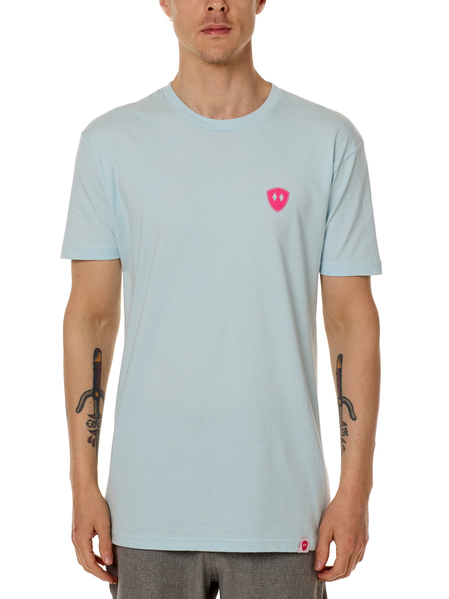 Front view of a male model wearing the Till I Die Bike V-Neck Tee in Light Blue on a white background. The shirt features a pink Double Diamond Shield logo on the wearer's left chest.