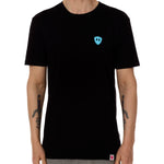 Front view of a male model wearing the Gear Head crew neck tee in black on a white background. Accented with a cyan blue double diamond shield over wearers left chest.