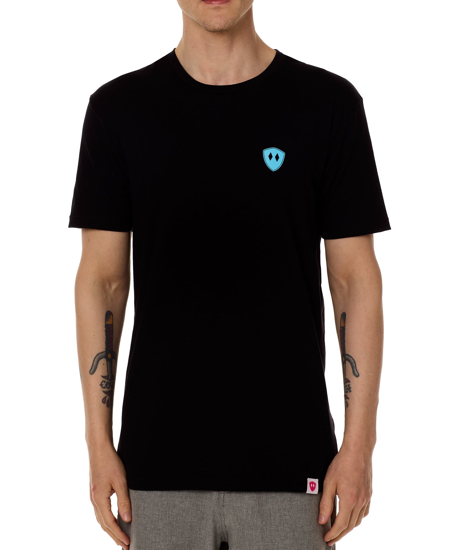 Front view of a male model wearing the Gear Head crew neck tee in black on a white background. Accented with a cyan blue double diamond shield over wearers left chest.