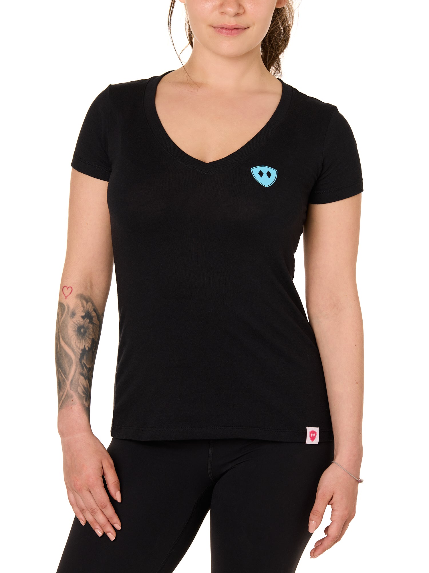 Front view of a female model wearing the Gear Head V neck tee in black on a white background. Accented with a cyan blue double diamond shield over wearers left chest.