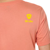 Back view of a male model wearing a sunset short sleeve shirt on a white background, featuring a yellow Till I Die logo on the wearer’s top right shoulder.