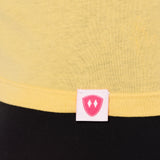 Close-up detail of a pink Double Diamond Shield woven hem label on a banana shirt.