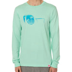 Front view of a male model wearing a long sleeve crew neck Mint Green T-Shirt. The graphic features a blue print of sunglasses with a tropical beach scene reflected in the lenses.