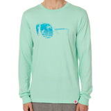 Front view of a male model wearing a long sleeve crew neck Mint Green T-Shirt. The graphic features a blue print of sunglasses with a tropical beach scene reflected in the lenses.