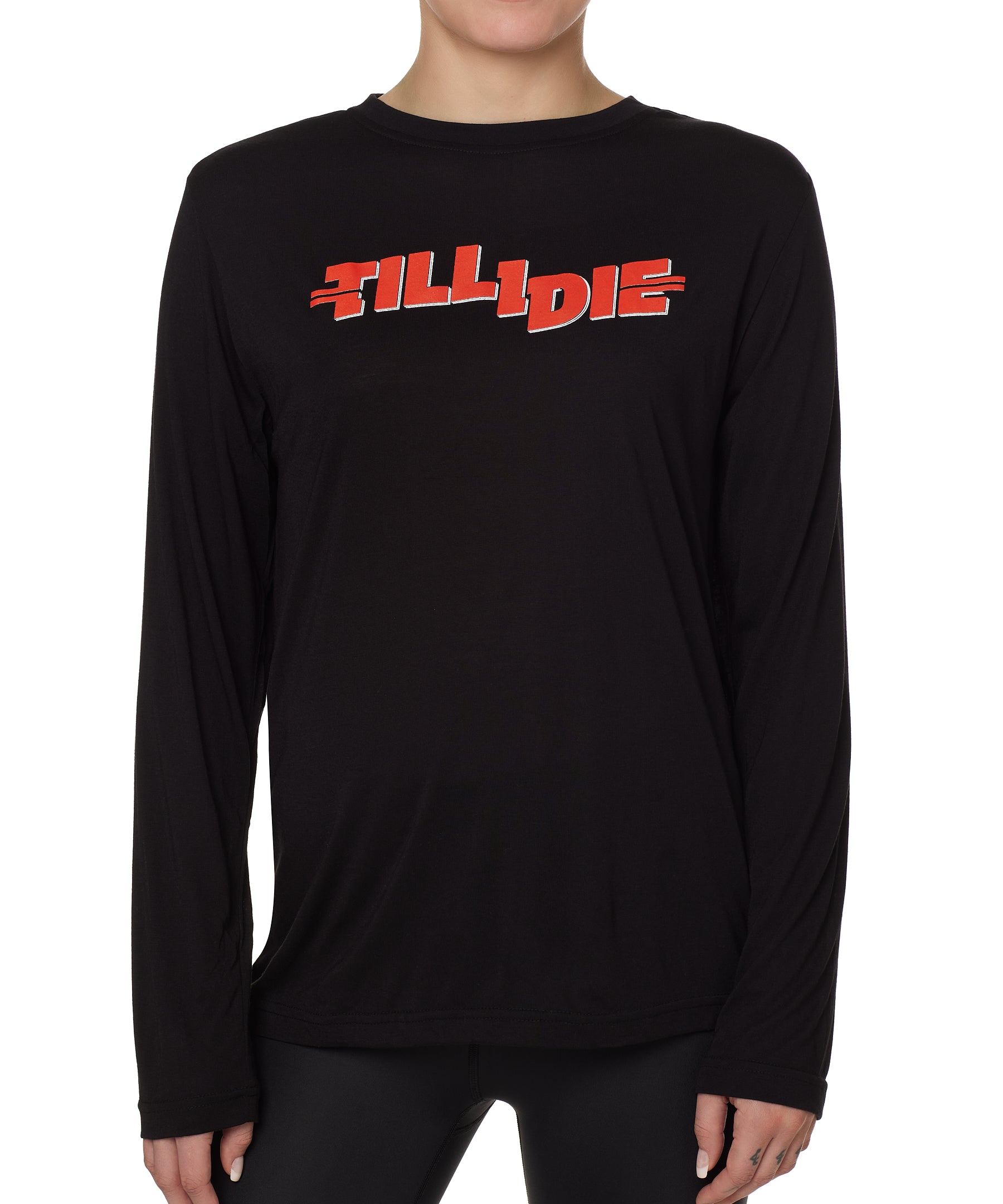 front view of a female model wearing the hot dog crew neck long sleeve tee in black. The graphic is red 'till i die' lettering inspired by the iconic title art for the 1984 ski move 'Hot Dog'