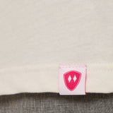 Close-up detail of a pink Double Diamond Shield woven hem label on a vintage white crew neck tee.