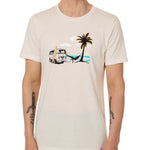 Front view of a male model wearing the Hammock crew neck tee in vintage white, displayed on a white background. The graphic depicts a vintage VW bus parked on a beach, with a surfboard leaning against it and a silhouetted figure relaxing in a hammock strung between the van and a palm tree.