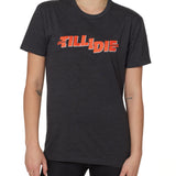 front view of a female model wearing the hot dog crew neck tee in heather charcoal. The graphic is red 'till i die' lettering inspired by the iconic title art for the 1984 ski move 'Hot Dog'