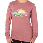 Front view of a female model wearing the Surf Truck long sleeve tee in deep sunset on a white background. The graphic features a classic green Bronco with a surfboard on the roof, parked in front of an ocean sunset, arched by “Till I Die” text.