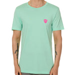 Front view of a male model wearing the Surfer Skeleton performance crew neck tee in mint green on a white background. Accented with a hot pink double diamond shield over wearers left chest.